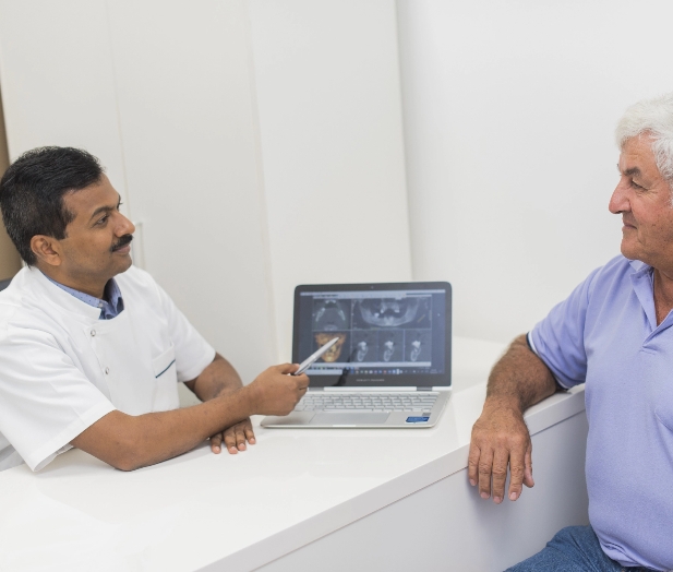Dr Raghu consulting a patient